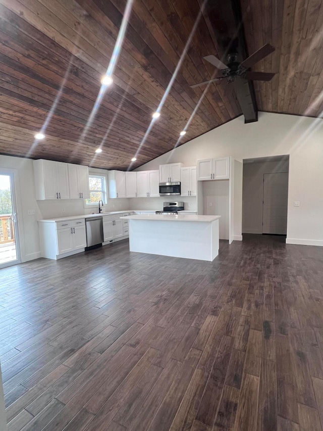 kitchen with stainless steel appliances, wooden ceiling, and dark wood finished floors