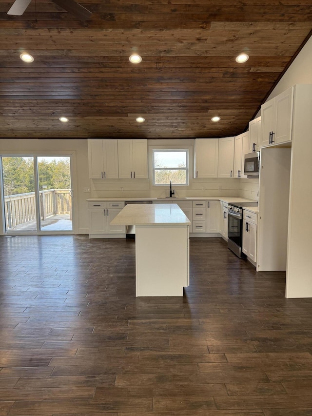 kitchen with wooden ceiling, stainless steel appliances, dark wood-type flooring, and light countertops