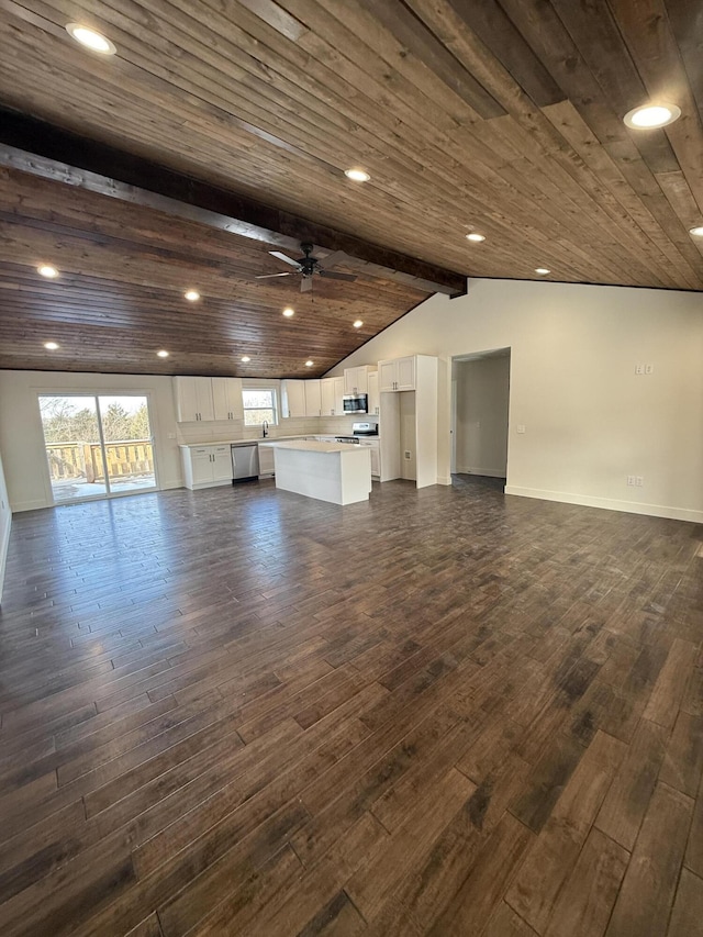 unfurnished living room featuring vaulted ceiling with beams, wooden ceiling, dark wood-style flooring, a ceiling fan, and baseboards