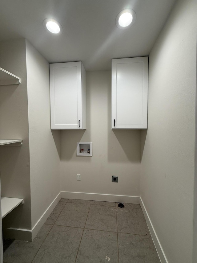 laundry area featuring hookup for a washing machine, cabinet space, electric dryer hookup, and baseboards