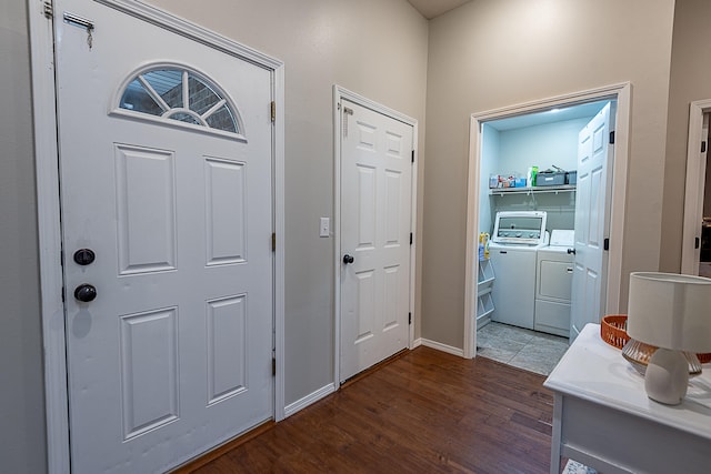 entryway with dark wood-type flooring and separate washer and dryer