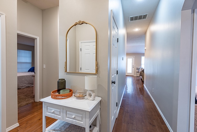 corridor featuring dark wood-type flooring