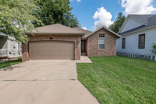 view of front of house featuring a front yard and a garage