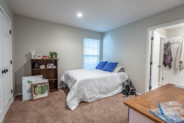 bedroom featuring carpet flooring, a spacious closet, and a closet