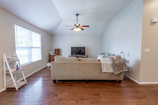 living room featuring dark wood-type flooring, ceiling fan, and vaulted ceiling