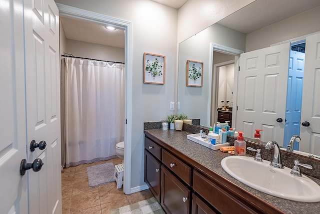 bathroom with toilet, a shower with curtain, vanity, and tile patterned flooring