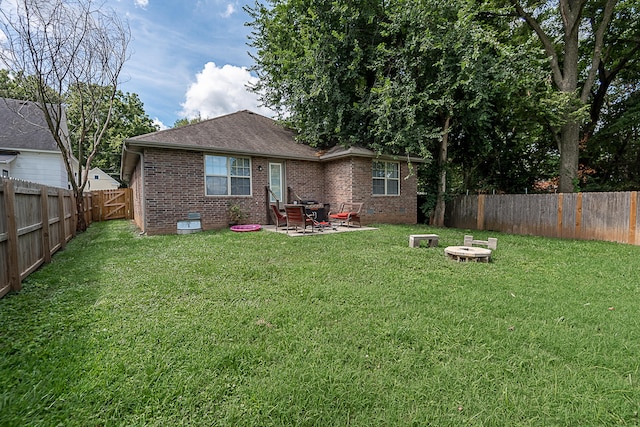 back of property featuring a lawn and a patio area