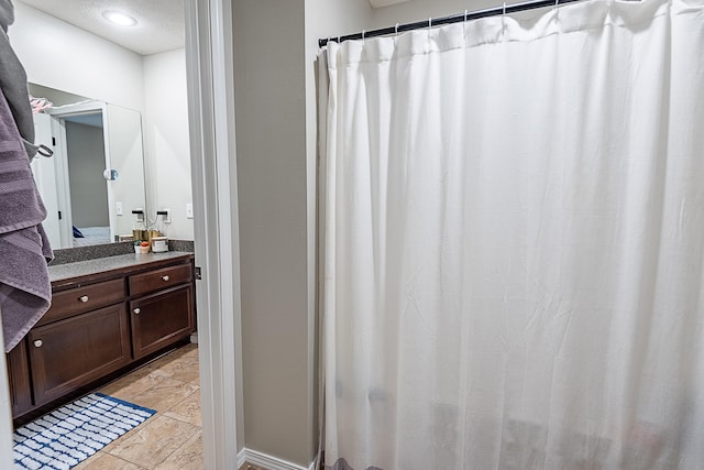 bathroom featuring tile patterned flooring and vanity