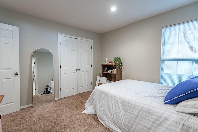 carpeted bedroom featuring a closet