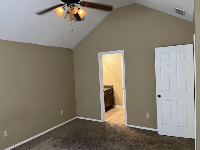 unfurnished bedroom featuring lofted ceiling, light carpet, ceiling fan, and ensuite bathroom