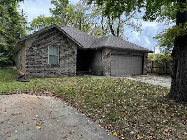 ranch-style home with a garage and a front yard