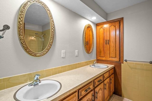 bathroom featuring tile walls, vanity, and tile patterned flooring