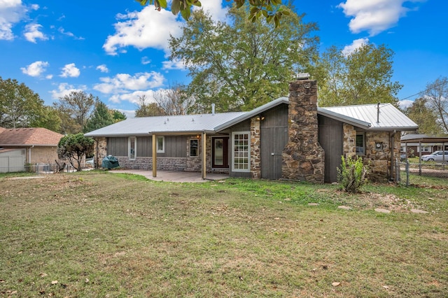 rear view of house featuring a patio and a yard