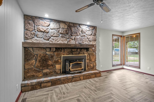 unfurnished living room with parquet flooring, ceiling fan, and a textured ceiling