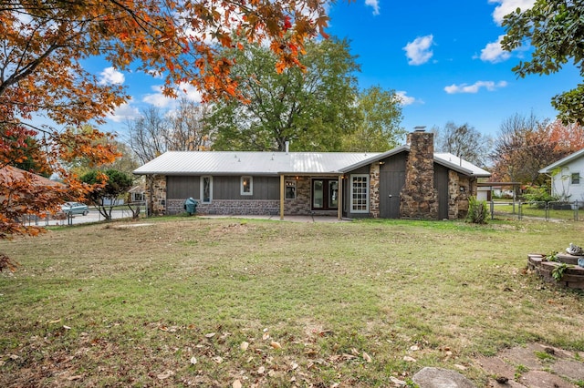 back of house with a patio and a lawn