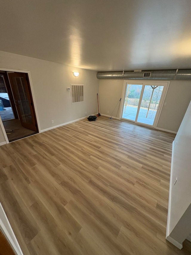 unfurnished living room with light hardwood / wood-style flooring