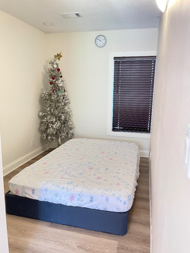 bedroom with hardwood / wood-style floors