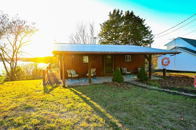 rear view of house featuring a patio area and a yard