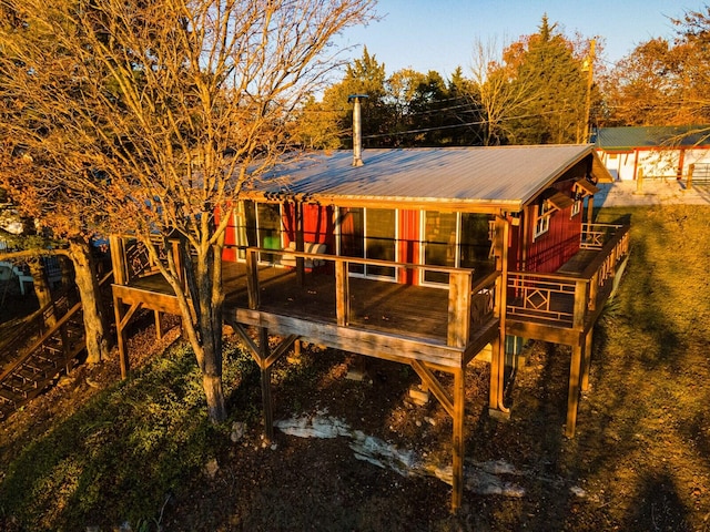 rear view of house featuring a deck