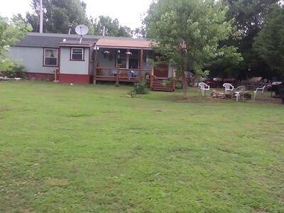 rear view of house featuring a yard