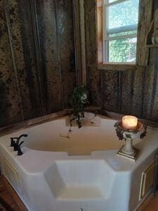 bathroom featuring a tub to relax in