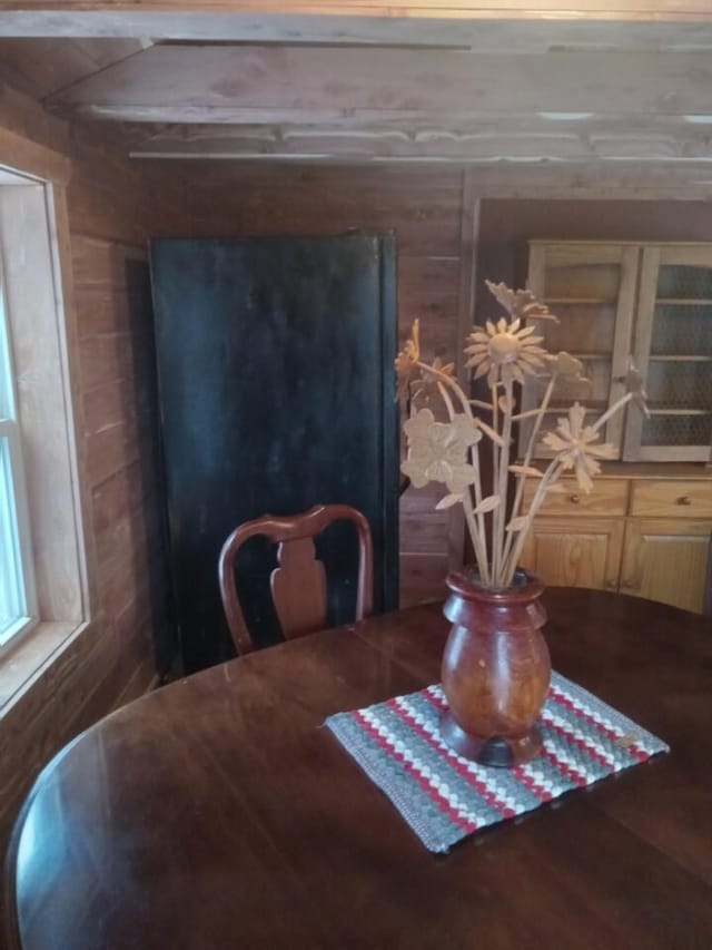 dining room with wood walls