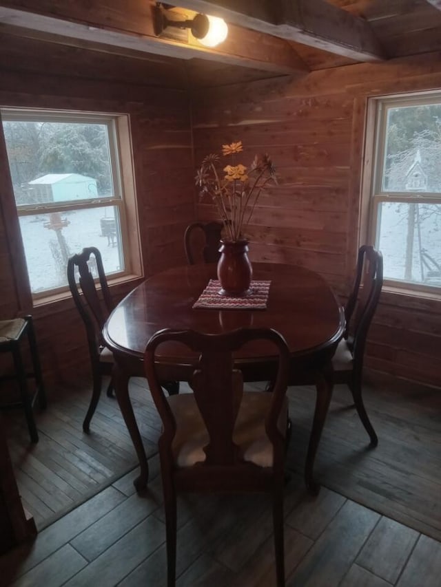 dining area with wood walls and hardwood / wood-style flooring