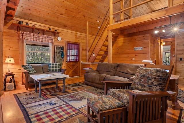 living room with hardwood / wood-style flooring, wooden ceiling, and wood walls