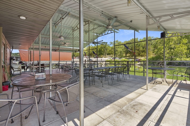 view of patio / terrace featuring ceiling fan and a water view