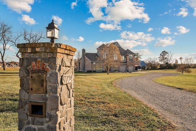 view of home's community featuring a lawn