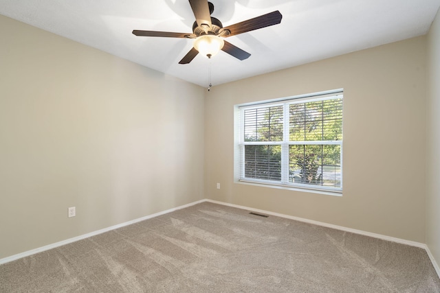 carpeted empty room featuring ceiling fan