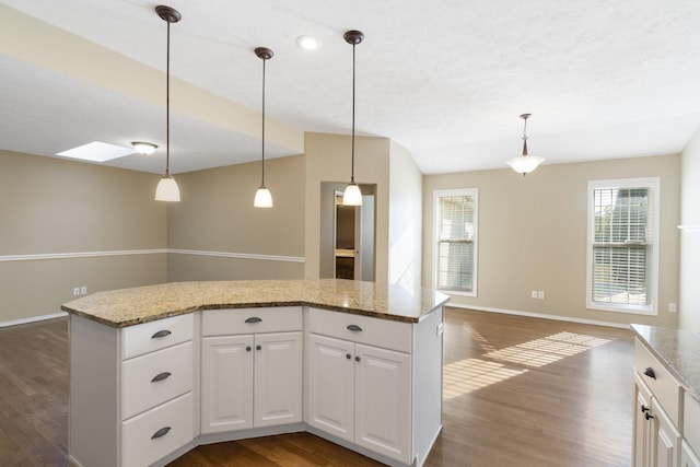 430 S Yellowwood Dr, Springfield, MO 65809 - kitchen with dark wood-style floors, baseboards, open floor plan, a kitchen island, and white cabinetry