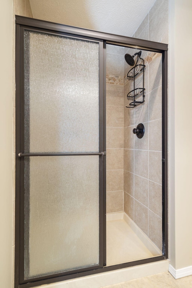 bathroom with a shower with shower door