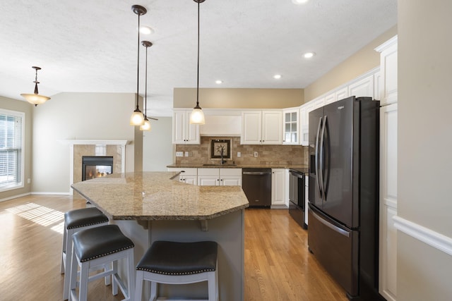430 S Yellowwood Dr, Springfield, MO 65809 - kitchen featuring refrigerator with ice dispenser, stainless steel dishwasher, a sink, decorative backsplash, and light wood finished floors