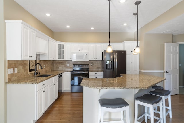 kitchen with dark hardwood / wood-style flooring, white cabinetry, appliances with stainless steel finishes, and sink