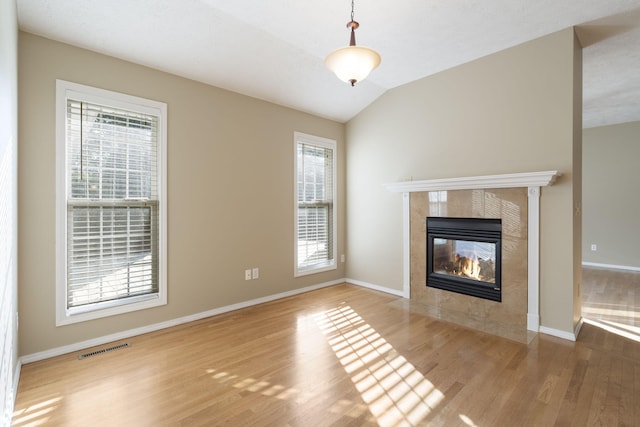 430 S Yellowwood Dr, Springfield, MO 65809 - unfurnished living room with a tile fireplace, wood finished floors, healthy amount of natural light, baseboards, and vaulted ceiling