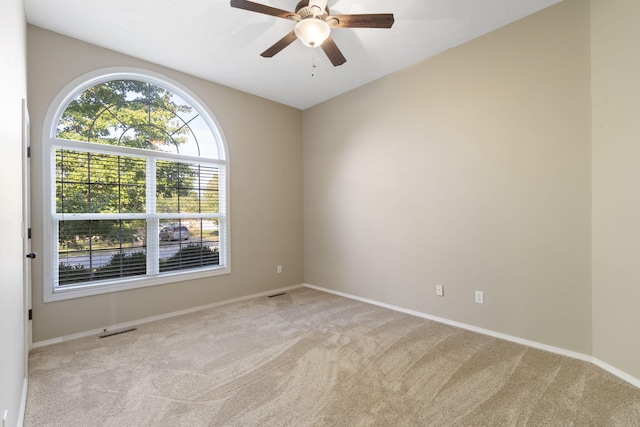 carpeted spare room with ceiling fan