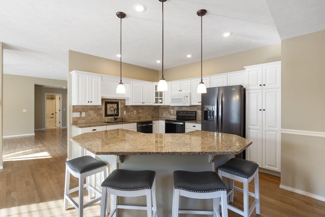 430 S Yellowwood Dr, Springfield, MO 65809 - kitchen with stainless steel appliances, a sink, baseboards, wood finished floors, and backsplash