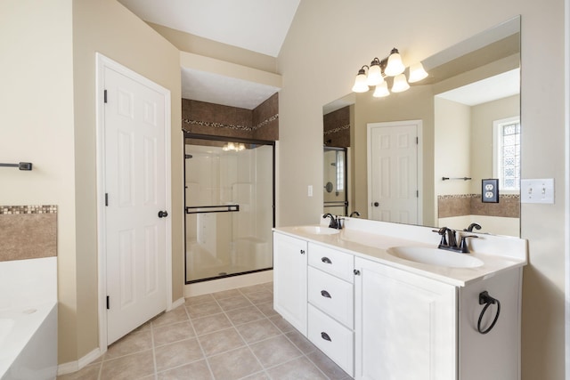 bathroom with vanity, tile patterned floors, separate shower and tub, and vaulted ceiling