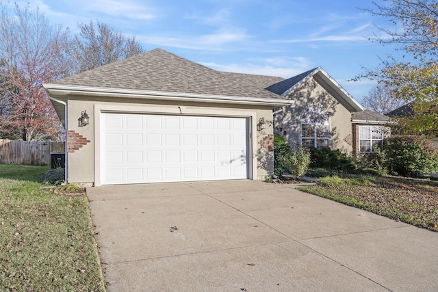 430 S Yellowwood Dr, Springfield, MO 65809 - view of front facade featuring stucco siding, concrete driveway, roof with shingles, and fence