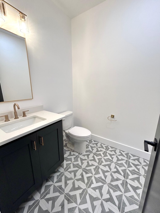 bathroom featuring tile patterned floors, vanity, and toilet