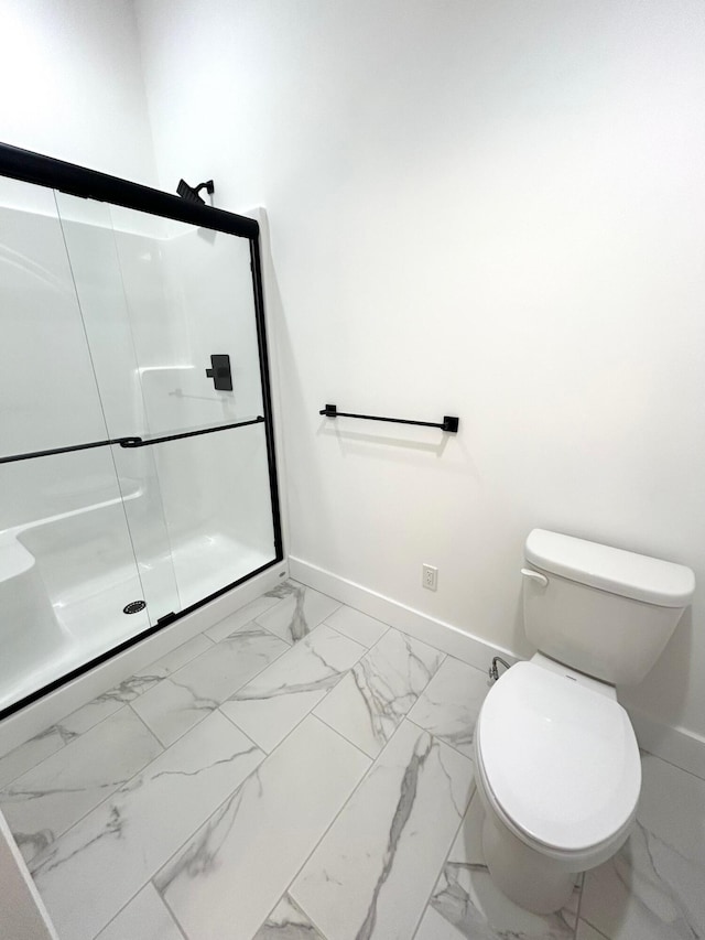 bathroom featuring toilet and walk in shower