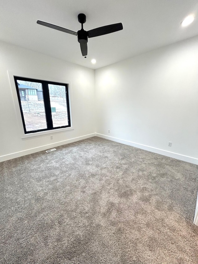 spare room featuring ceiling fan and carpet floors