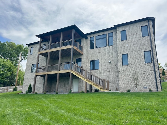 2979 E Kemmling Ln, Springfield, MO 65804 - rear view of property featuring a balcony, a lawn, stairs, and brick siding