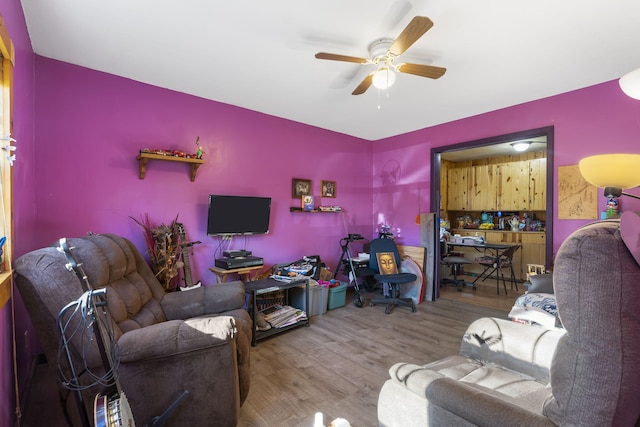 living room with hardwood / wood-style flooring and ceiling fan