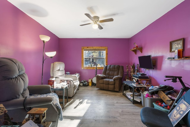 living room with hardwood / wood-style flooring and ceiling fan