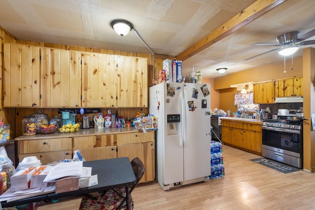 kitchen with sink, white fridge with ice dispenser, ceiling fan, gas stove, and light hardwood / wood-style flooring