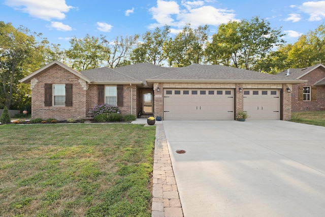 view of front of property with a garage and a front lawn