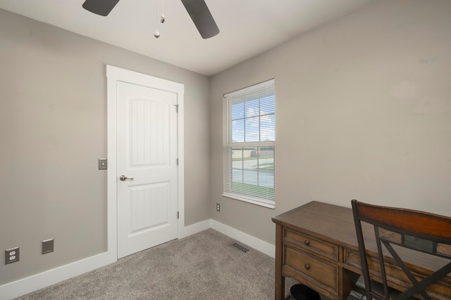 carpeted office space featuring ceiling fan