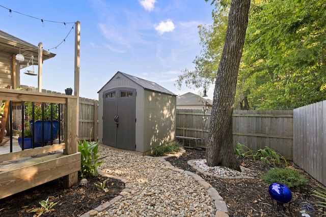 view of yard with a wooden deck and a storage unit